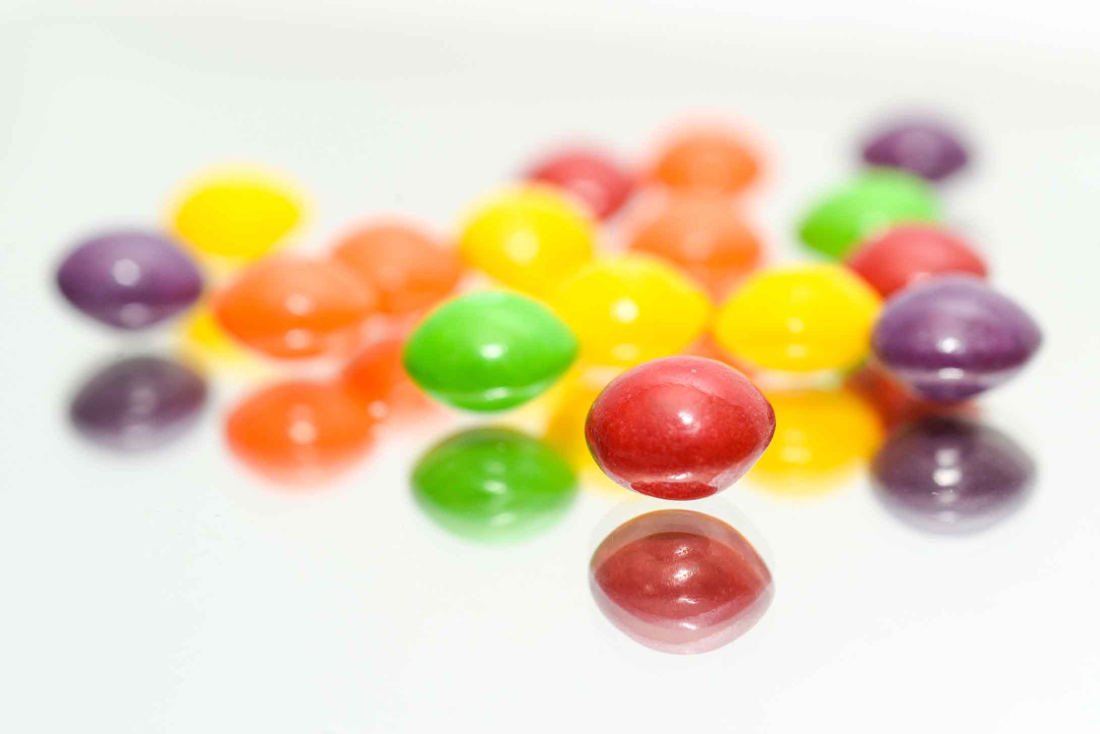 a bunch of skittles candy on a table