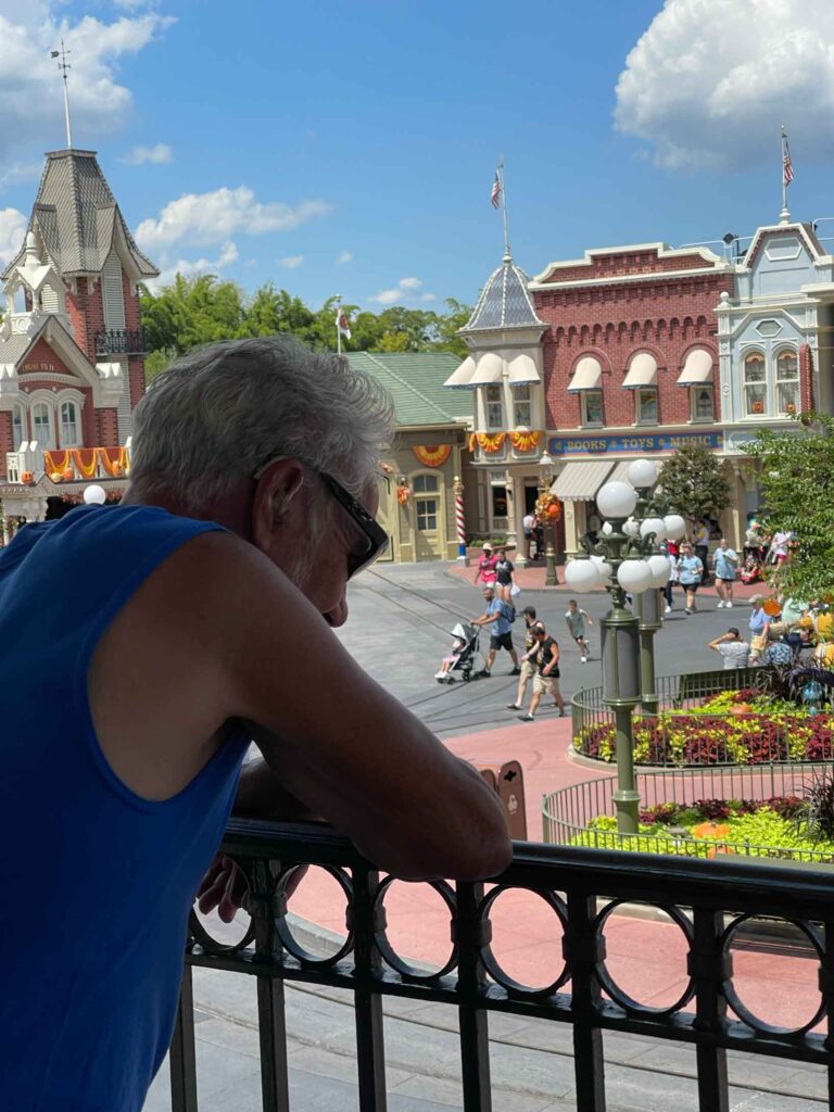 dad looking at Main Street from the top of the train station in Magic Kingdom
