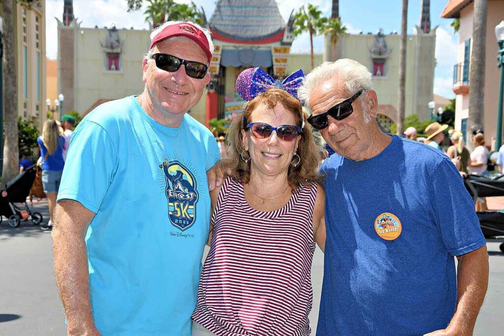 a picture of three people celebrating a first visit at Hollywood Studios